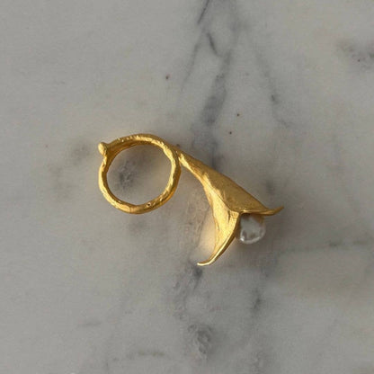 Trebor Style calla lily ring in brushed 24k gold filled finish with a central lustrous biwa pearl on marble surface