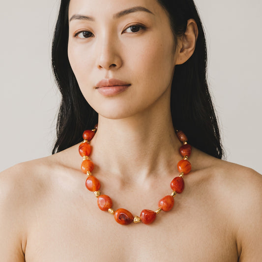 Trebor Style organic carnelian gemstone necklace with gold-plated brass toggle clasp worn by a woman
