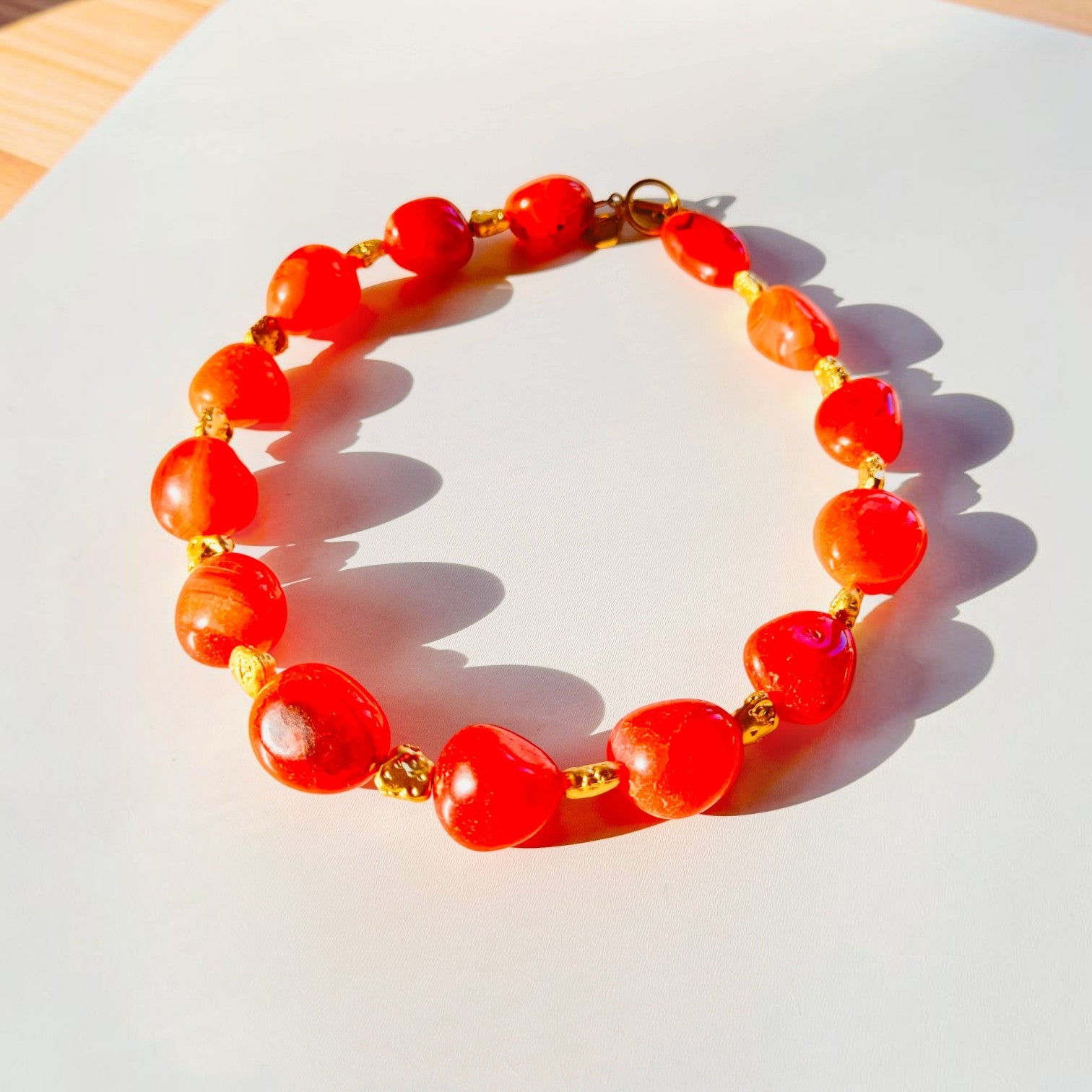 Trebor Style organic carnelian statement necklace with vibrant orange gemstones and gold plated brass toggle clasp