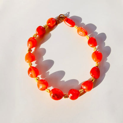 Trebor Style organic carnelian gemstone necklace with gold-plated brass toggle clasp and vibrant orange stones.