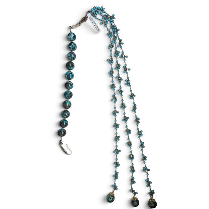 Trebor Style asymmetrical necklace featuring large chrysocolla beads and three strands of turquoise tassel beads.