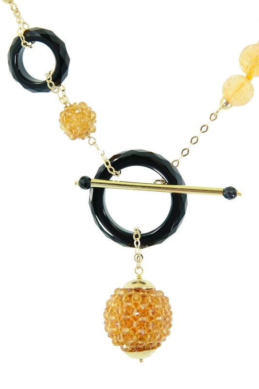 Trebor Style Rajola 18k gold necklace featuring faceted citrine beads and black onyx rings with a toggle closure.