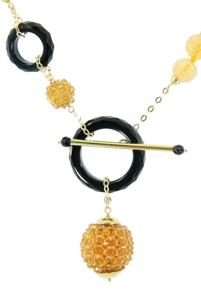 Trebor Style Rajola 18k gold necklace featuring faceted citrine beads and black onyx rings with a toggle closure.