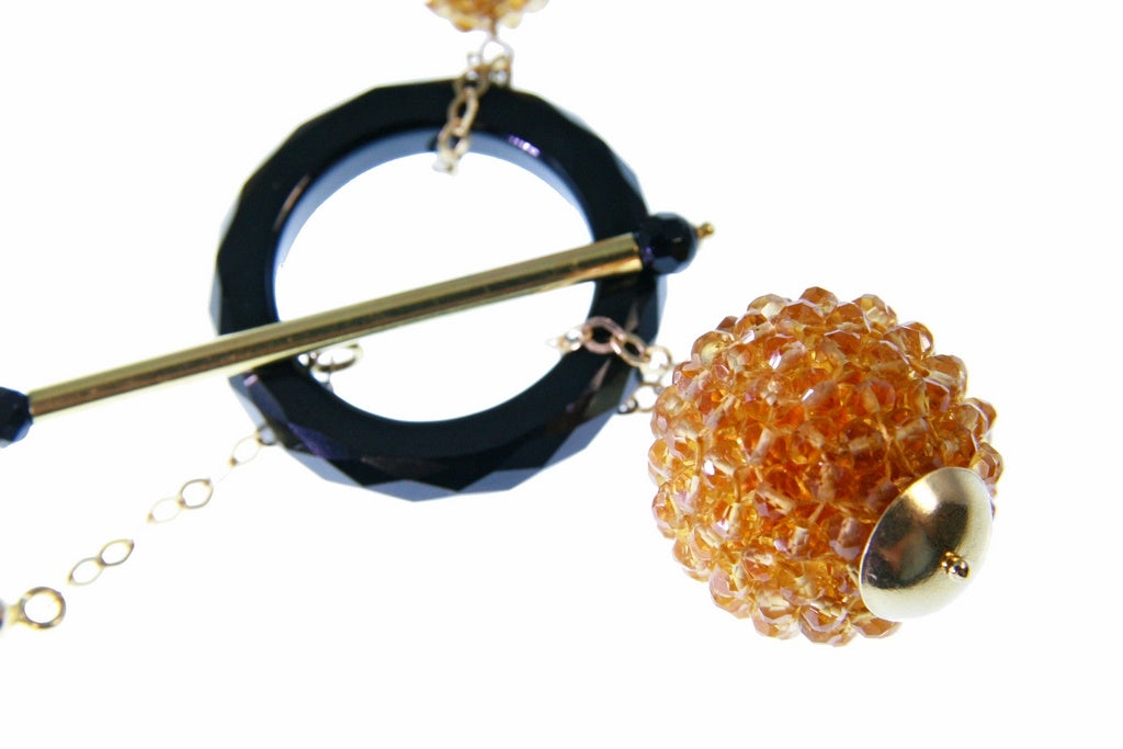 Trebor Style Rajola necklace featuring a faceted citrine bead sphere, black onyx ring, and 18k yellow gold toggle.
