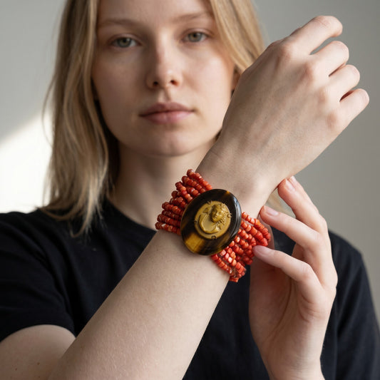 Trebor Style coral beaded cuff bracelet featuring a horn medallion with an antique cameo worn on a model's wrist.
