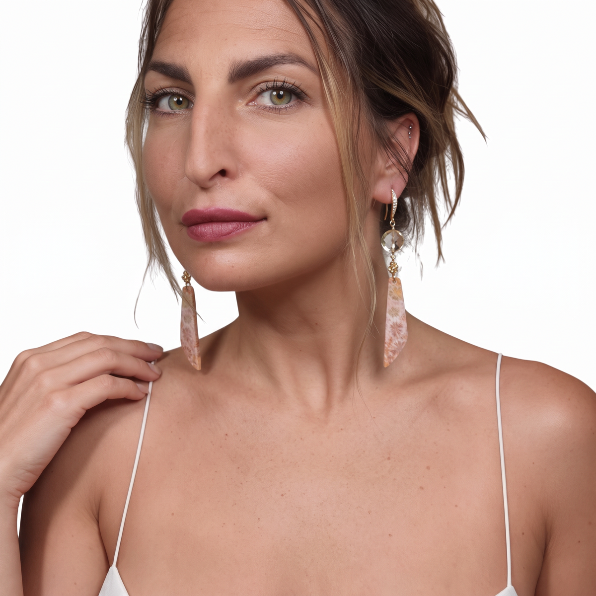 Trebor Style crystal quartz and fossil coral drop earrings with 14k gold and CZ pavé worn by a woman.