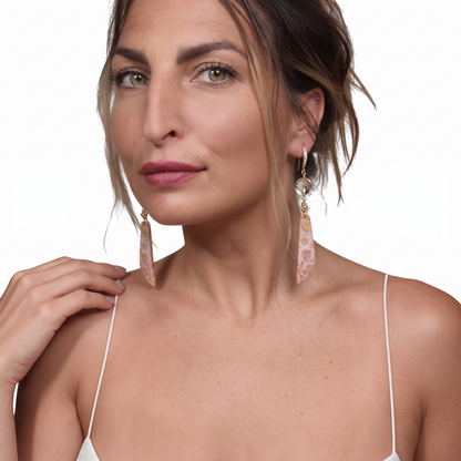 Trebor Style crystal quartz and fossil coral drop earrings with 14k gold and CZ pavé worn by a woman.