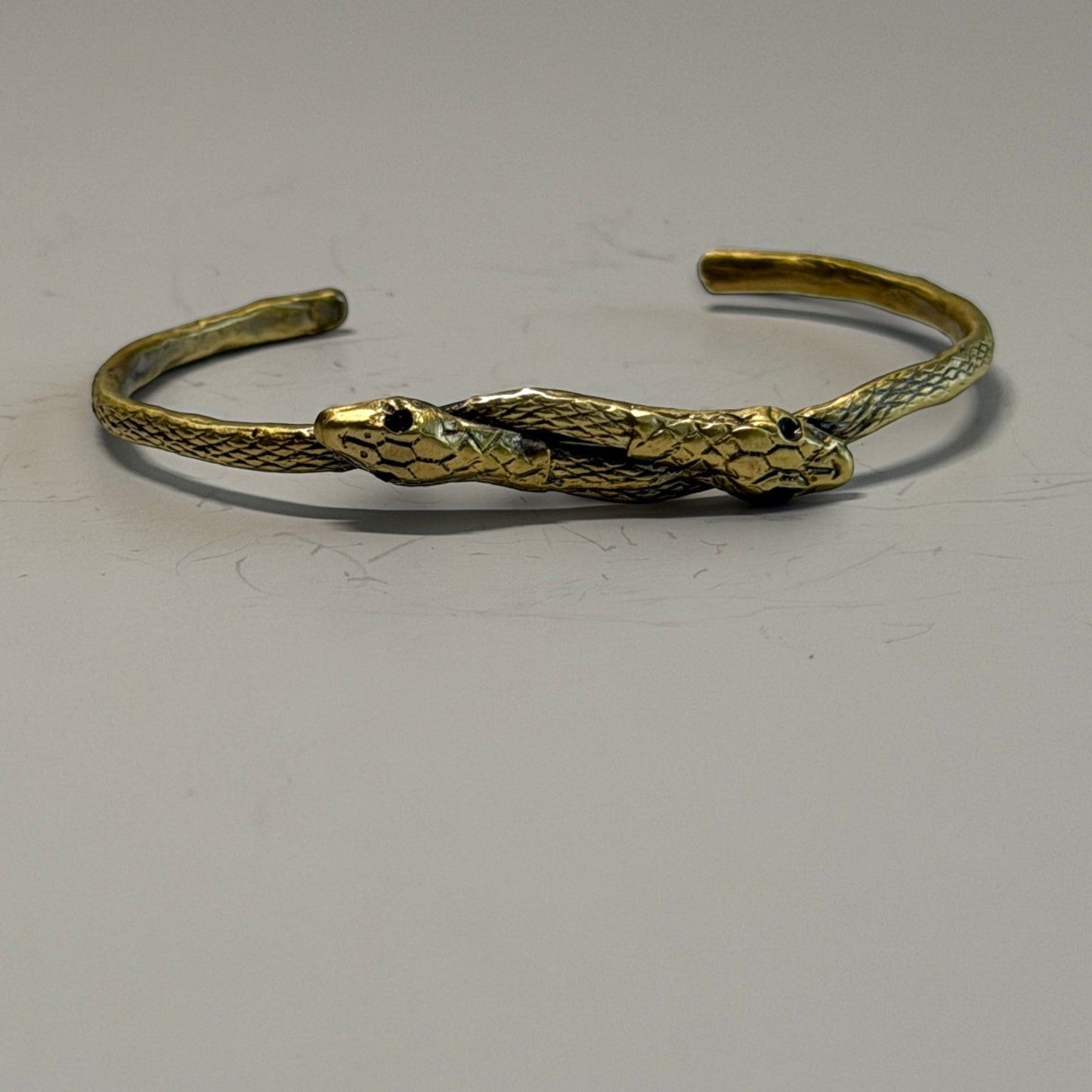 Trebor Style thin double serpent bangle in reclaimed copper and zinc with an Austrian crystal eye detail