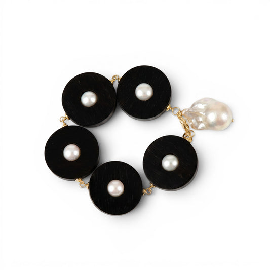 Trebor Style bracelet featuring black ebony circular links with white freshwater pearls and a baroque pearl charm drop.