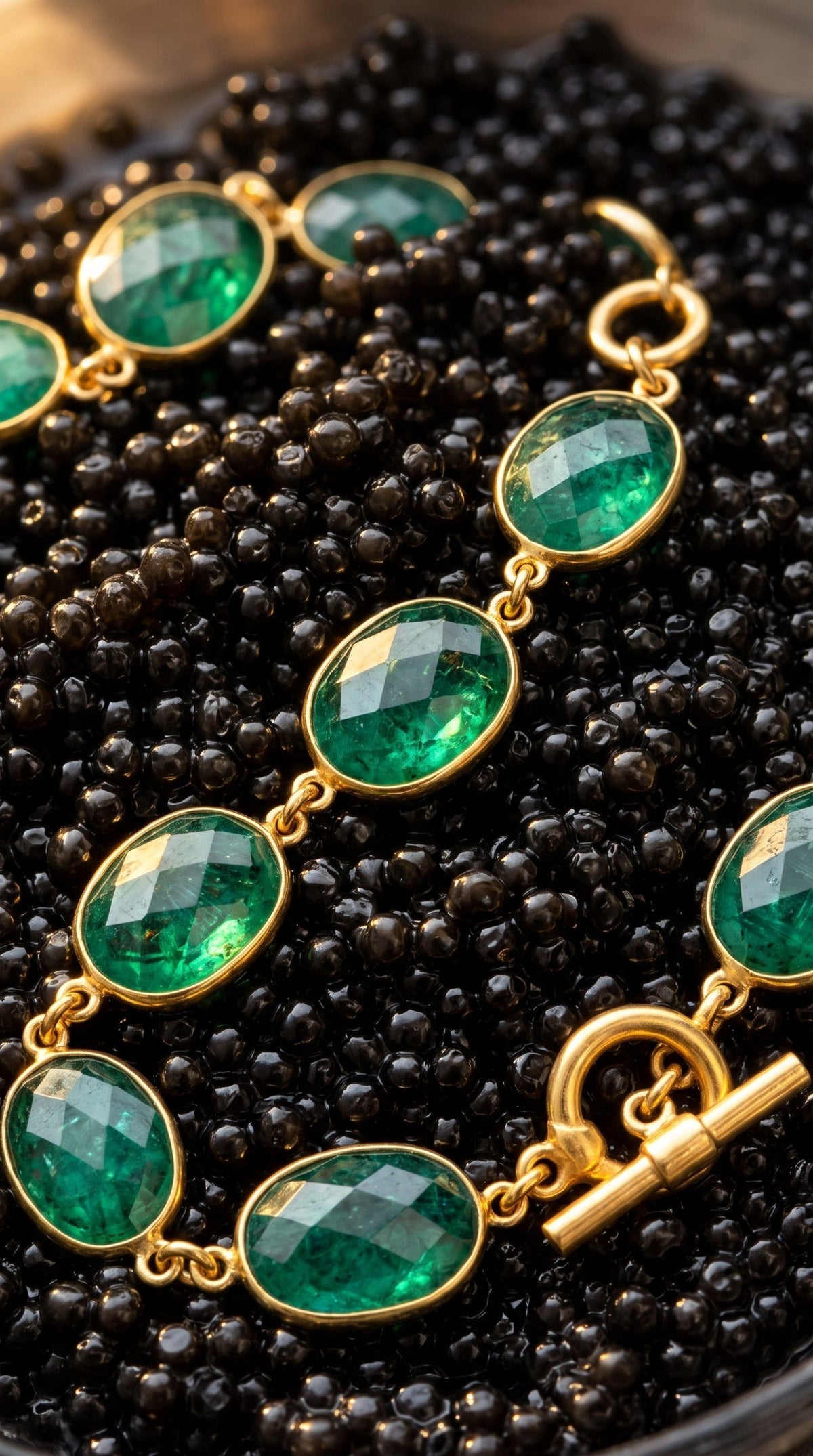 Trebor Style faceted oval emerald necklace with vintage brass bezel settings and a toggle clasp on black beads.