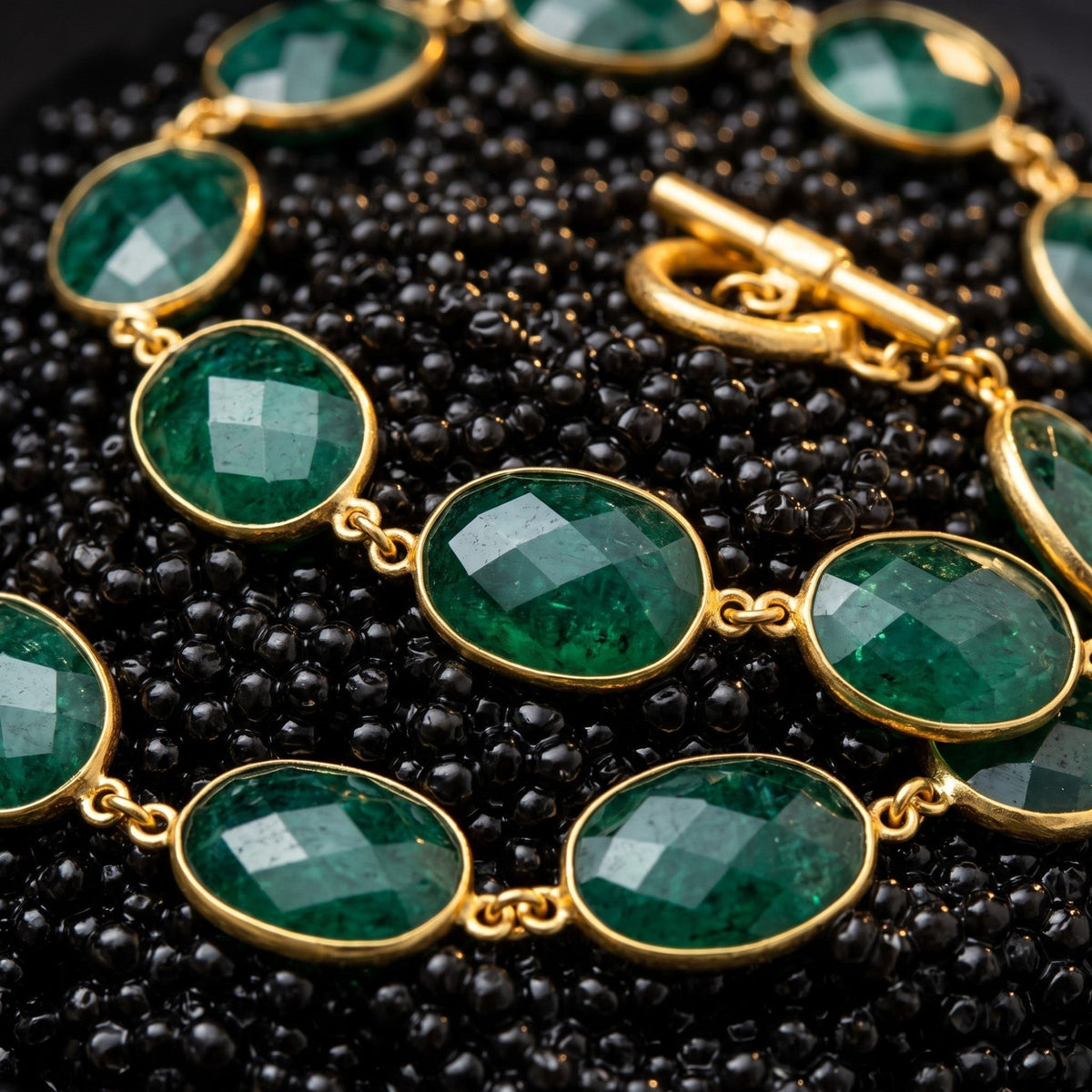 Trebor Style faceted oval emerald necklace with vintage brass bezel settings and a toggle clasp.