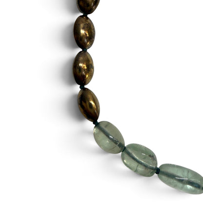 Trebor Style handcrafted statement necklace featuring pale green fluorite beads and metallic bronze oval accents.