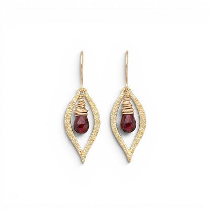Trebor Style Dew earrings featuring faceted red garnet briolettes wrapped in 14k gold-filled wire inside brass leaf frames.
