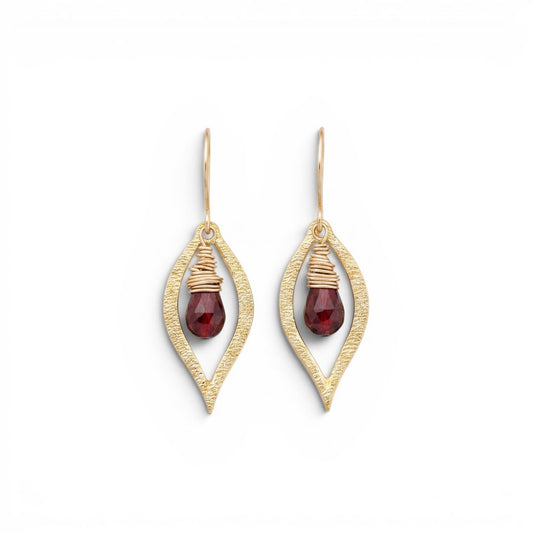 Trebor Style Dew earrings featuring faceted red garnet briolettes wrapped in 14k gold-filled wire inside brass leaf frames.