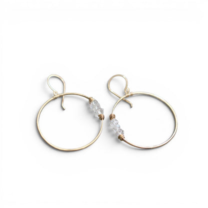 Trebor Style Gemini hoop earrings in 14k gold fill featuring hand-hammered wire and natural Herkimer diamond accents.