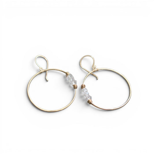Trebor Style Gemini hoop earrings in 14k gold fill featuring hand-hammered wire and natural Herkimer diamond accents.