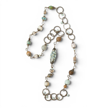 Trebor Style collage necklace featuring antique brass rings, Czech glass beads, and gemstones in a rustic design.