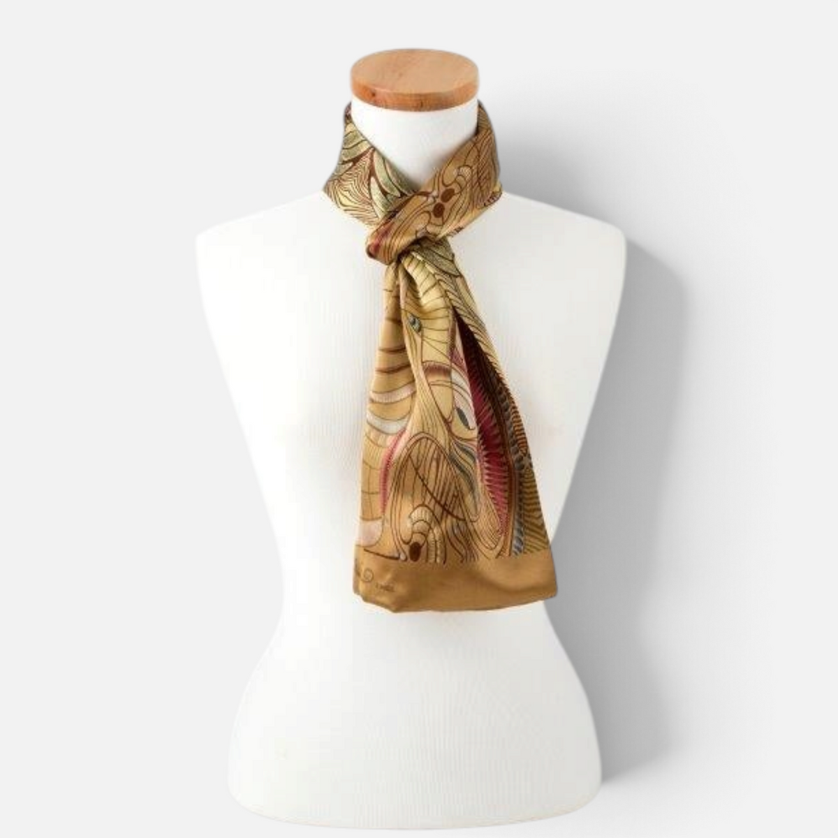 Trebor Style silk satin tube scarf featuring a gold and beige jungle print pattern on a white mannequin display.