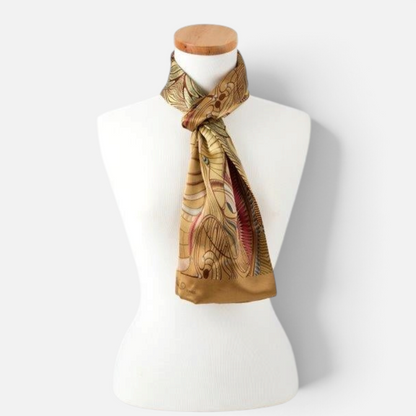 Trebor Style silk satin tube scarf featuring a gold and beige jungle print pattern on a white mannequin display.