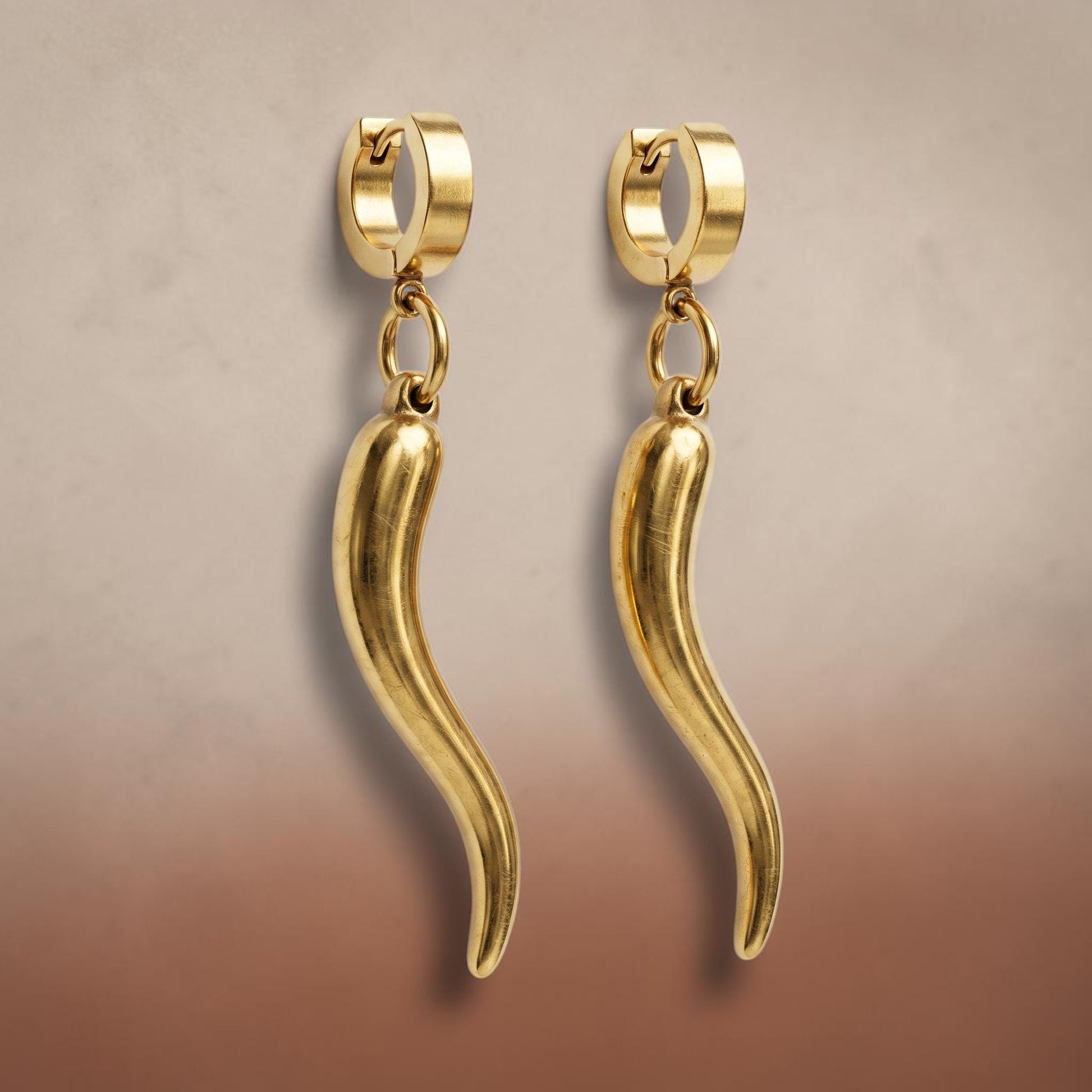 Trebor Style gold-filled chili pepper charm hoop earrings made from stainless steel, featuring a sleek dangling design.