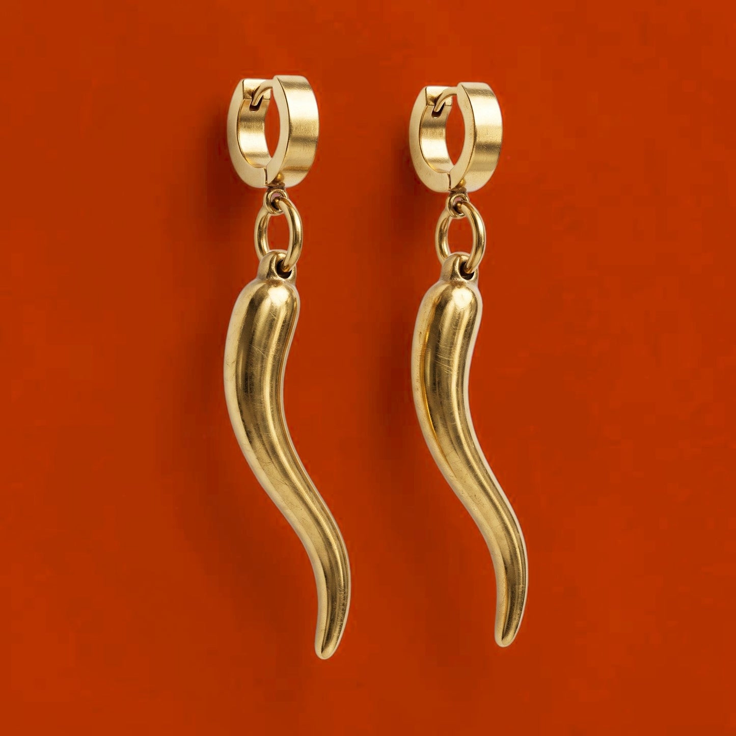 Trebor Style gold-filled chili pepper charm hoop earrings made from stainless steel, featuring a sleek dangling design.