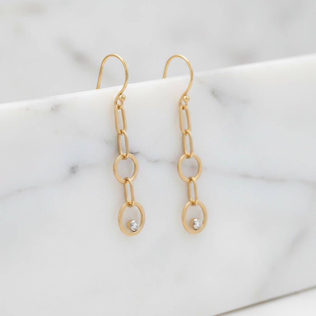 Trebor Style gold-filled double circle drop earrings with lab-grown diamonds on French hooks against marble background