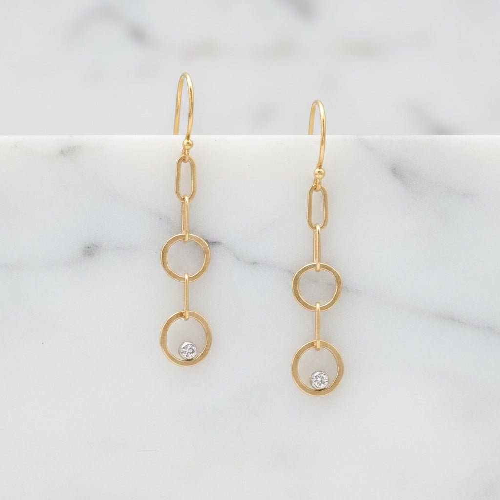 Trebor Style gold-filled double circle drop earrings with lab-grown diamonds on French hooks against marble background