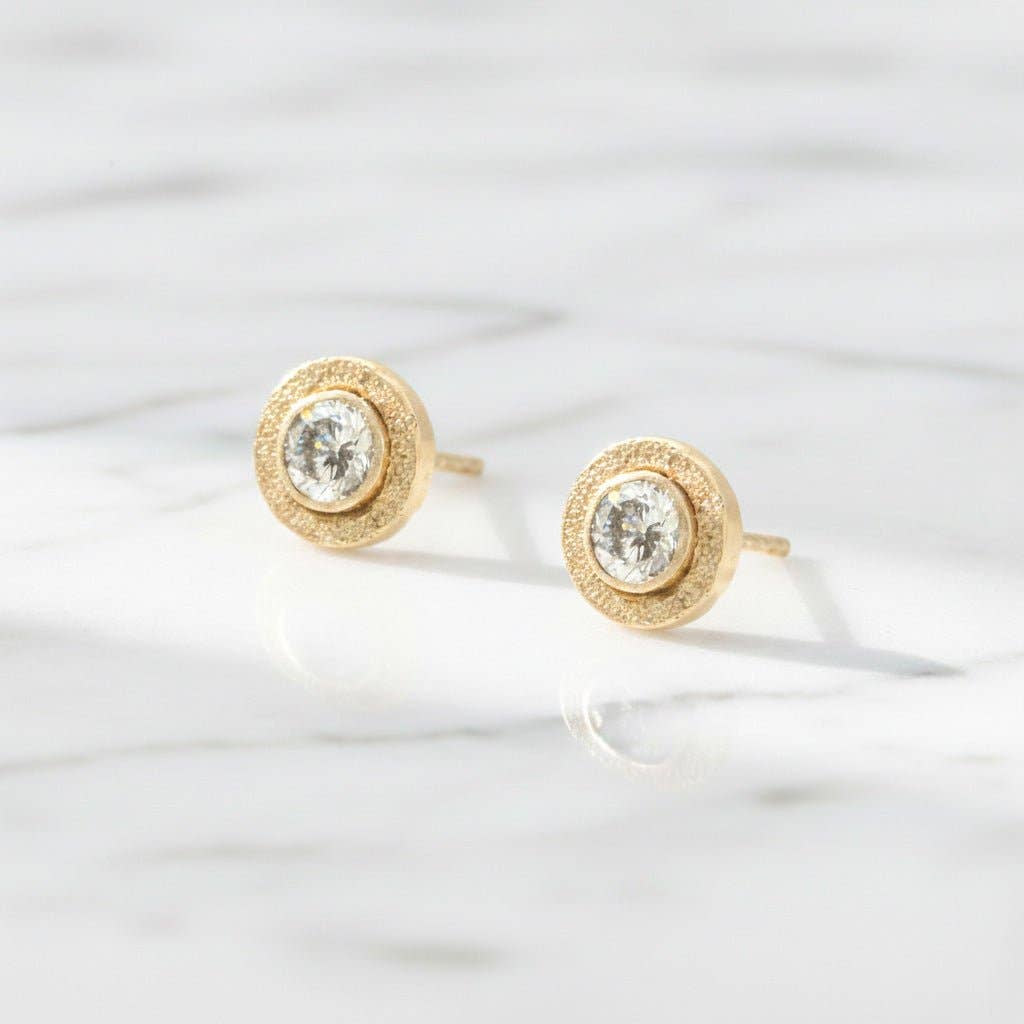 Trebor Style 14kt gold-filled bezel stud earrings featuring 4mm round lab-grown diamonds on a white marble surface.
