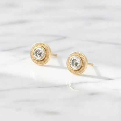 Trebor Style 14kt gold-filled bezel stud earrings featuring 4mm round lab-grown diamonds on a white marble surface.