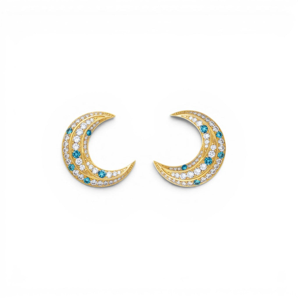 Trebor Style La Luna gold-plated crescent moon earrings with blue and white zirconia stones on a white background.