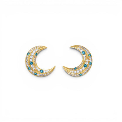 Trebor Style La Luna gold-plated crescent moon earrings with blue and white zirconia stones on a white background.