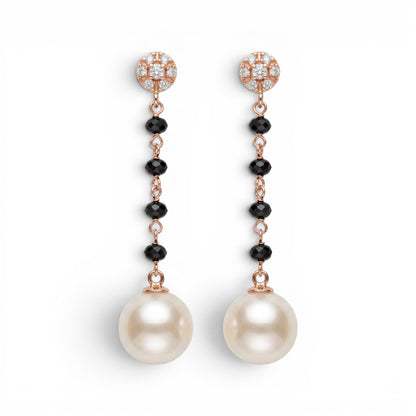 Trebor Style 18k gold drop earrings featuring diamond studs, black onyx beads, and large white cultured pearls.