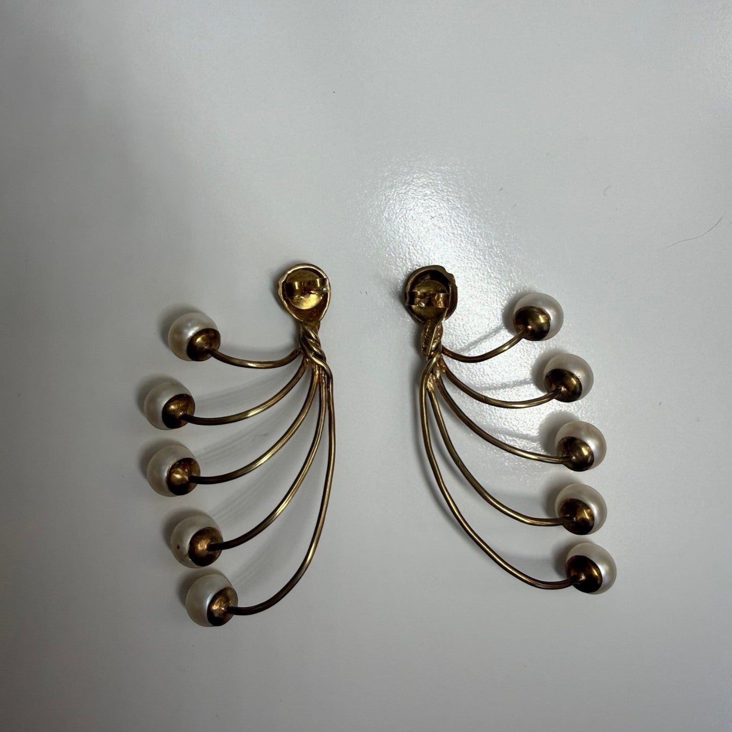 Trebor Style gold-tone fan-style earrings featuring five cascading cream faux pearls in a vintage-inspired design.