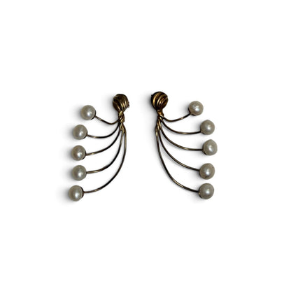 Trebor Style gold-tone fan-style statement earrings with cascading cream faux pearls on a white surface.
