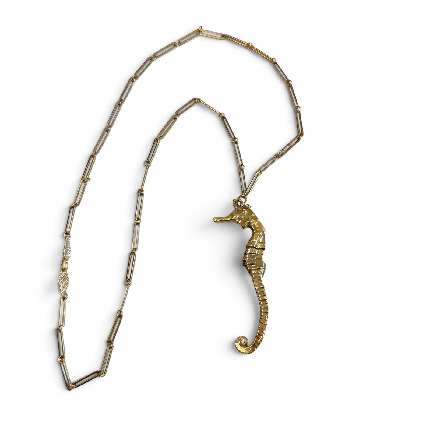 Trebor Style gold seahorse pendant necklace on a delicate paperclip chain with an intricate leaf clasp detail