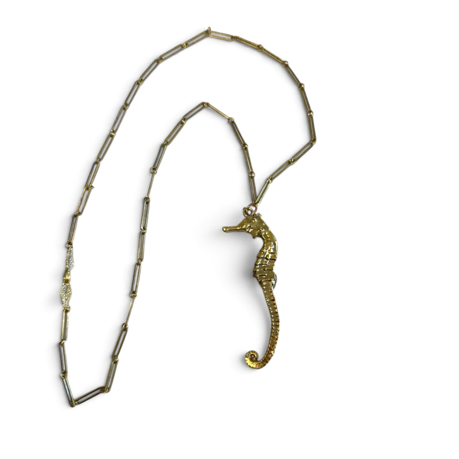 Trebor Style gold seahorse pendant necklace with a delicate link chain and intricate leaf clasp detail
