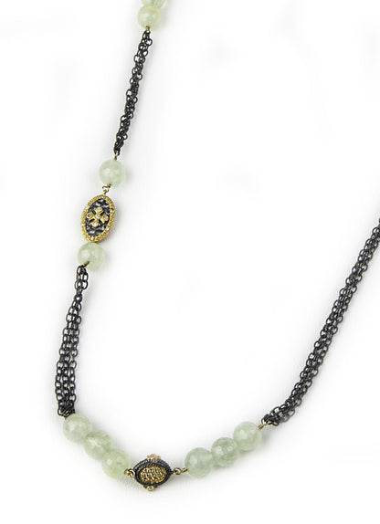 Trebor Style long necklace featuring faceted green tourmaline, 22k gold medallions, and white topaz on a dark chain.