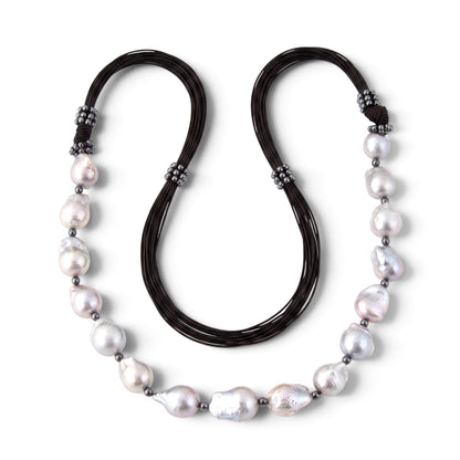 Trebor Style long necklace featuring grey baroque pearls and pyrite beads on multi-strand black cord, made in Italy.