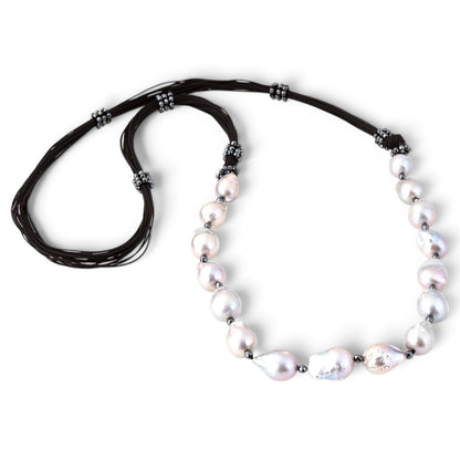 Trebor Style long necklace featuring large grey baroque pearls and sparkling pyrite beads on multi-strand black cord.