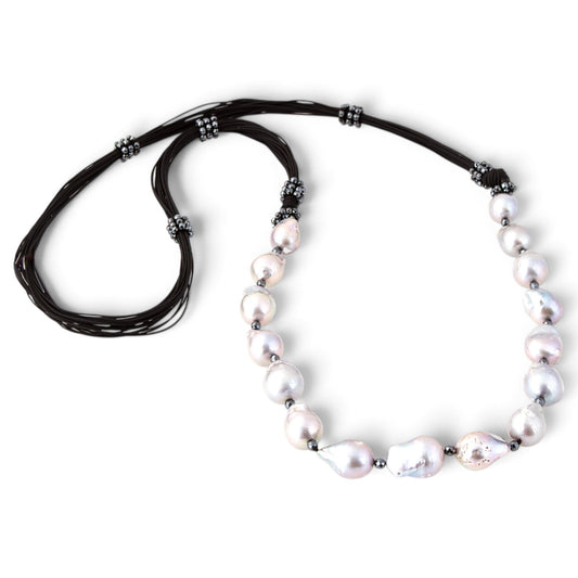 Trebor Style long necklace featuring large grey baroque pearls and sparkling pyrite beads on multi-strand black cord.