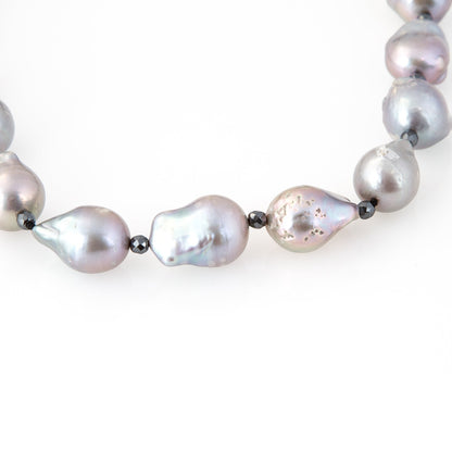 Trebor Style long necklace featuring large grey baroque pearls and sparkling pyrite bead accents on a cord strand.
