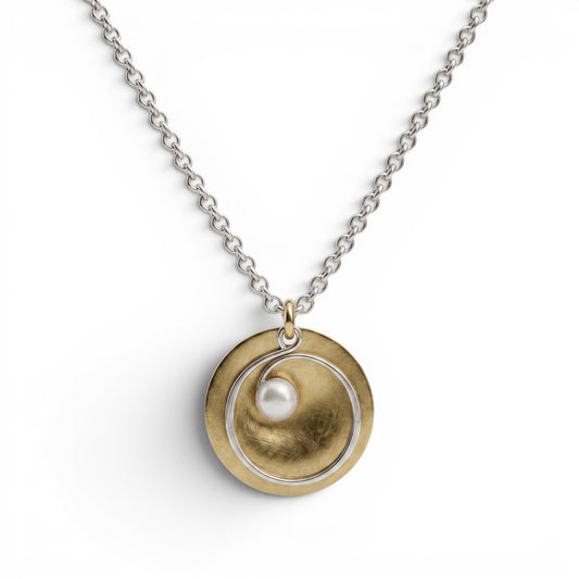 Trebor Style hammered brass disc pendant necklace with a silver spiral wire and white pearl on a silver link chain.