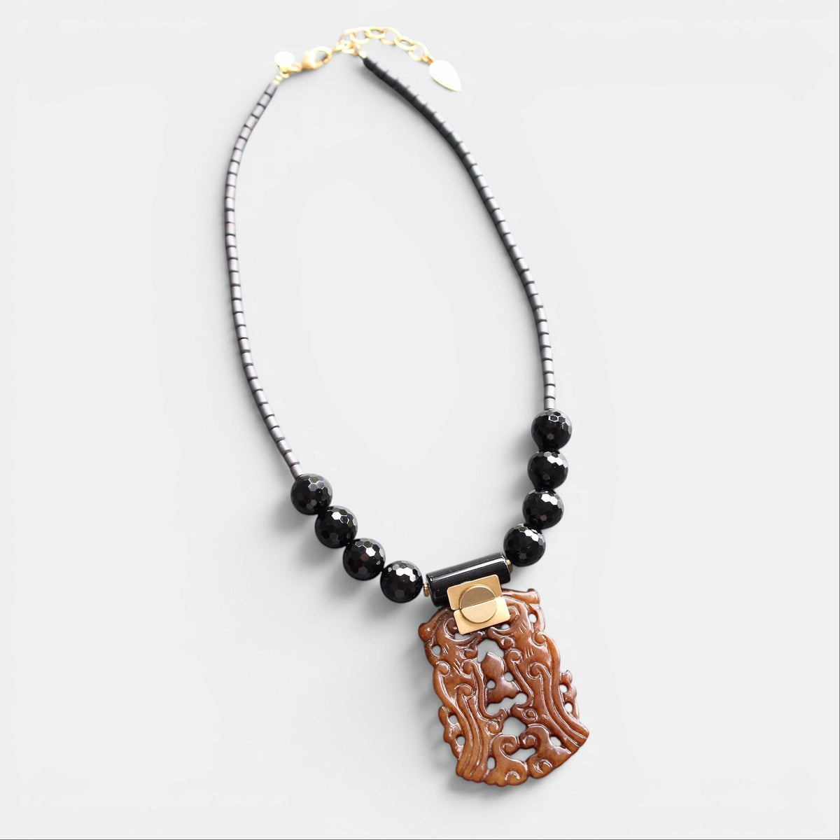 Trebor Style carved jade and black agate pendant necklace with hematite beads and gold-tone extender chain