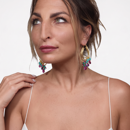 Trebor Style Jalila gold-plated 925 silver earrings with fuchsia and turquoise stones worn by a woman.