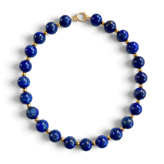 Trebor Style 20-inch statement necklace featuring 12mm natural blue lapis lazuli beads and gold-plated brass accents.