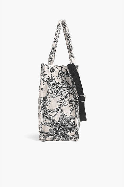 Trebor Style black and cream botanical leopard print jacquard tote bag, side view with detachable crossbody strap