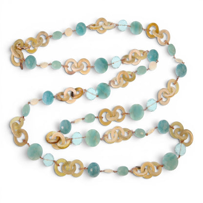 Trebor Style long necklace featuring tan horn, turquoise chalcedony, crystal, and pearl beads on rose gold silver chain.