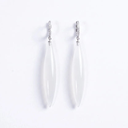 Trebor Style long drop earrings featuring translucent white stone pendants on silver-tone pavé hoop settings.