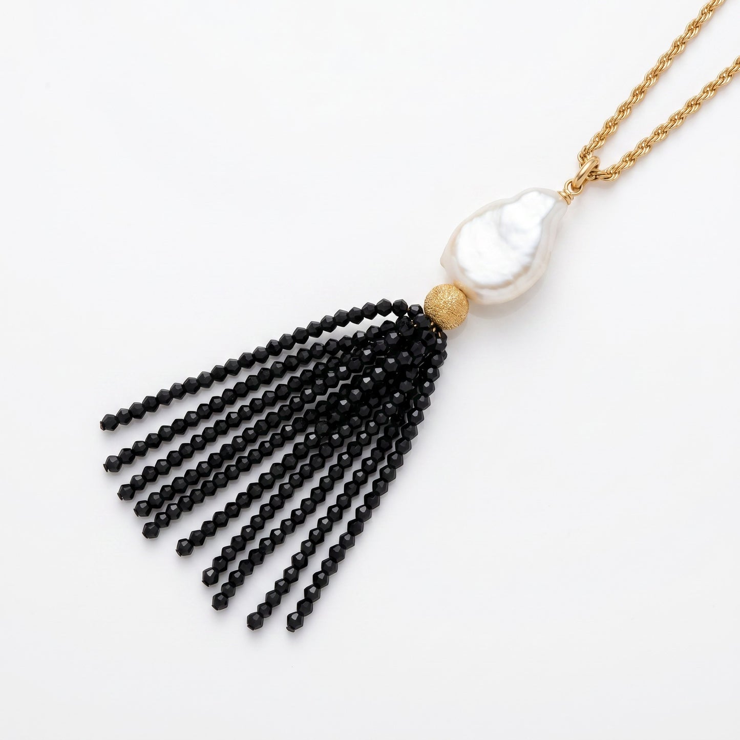 Trebor Style long necklace featuring a white Mabe pearl and a black spinel gemstone tassel on a gold-filled chain.
