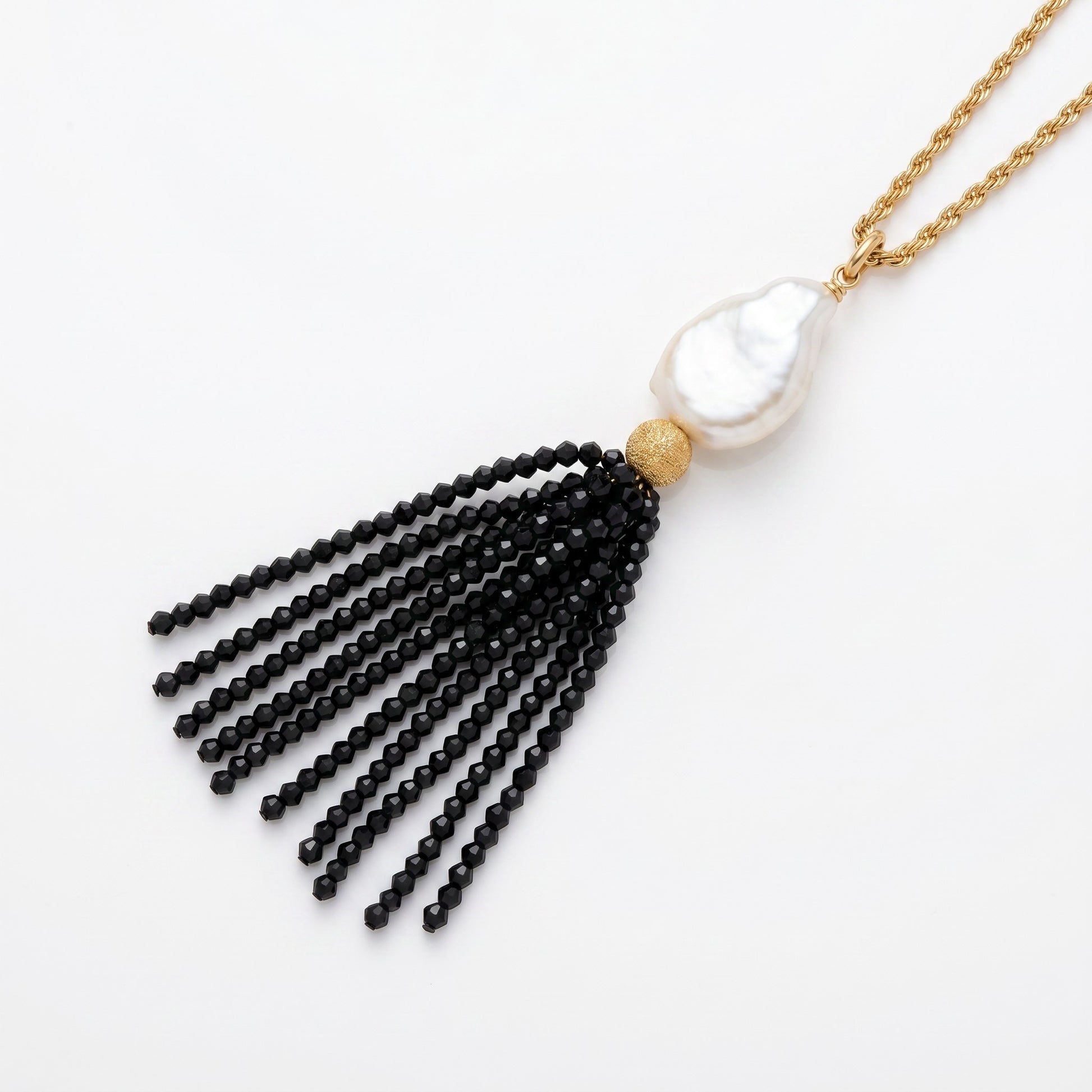 Trebor Style long necklace featuring a white Mabe pearl and a black spinel gemstone tassel on a gold-filled chain.